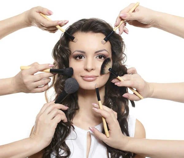 Beautiful long curly hair girl with makeup brush — Stock Photo, Image
