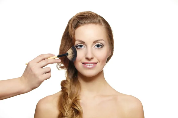 Makeup artist applying makeup to attractive blond girl, bright makeup, lon — Stock Photo, Image