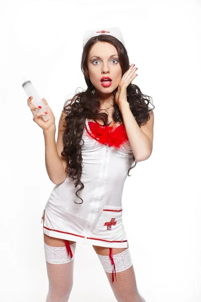 Sexy beautiful surprised female brunette doctor with big syringe red linger — Stock Photo, Image