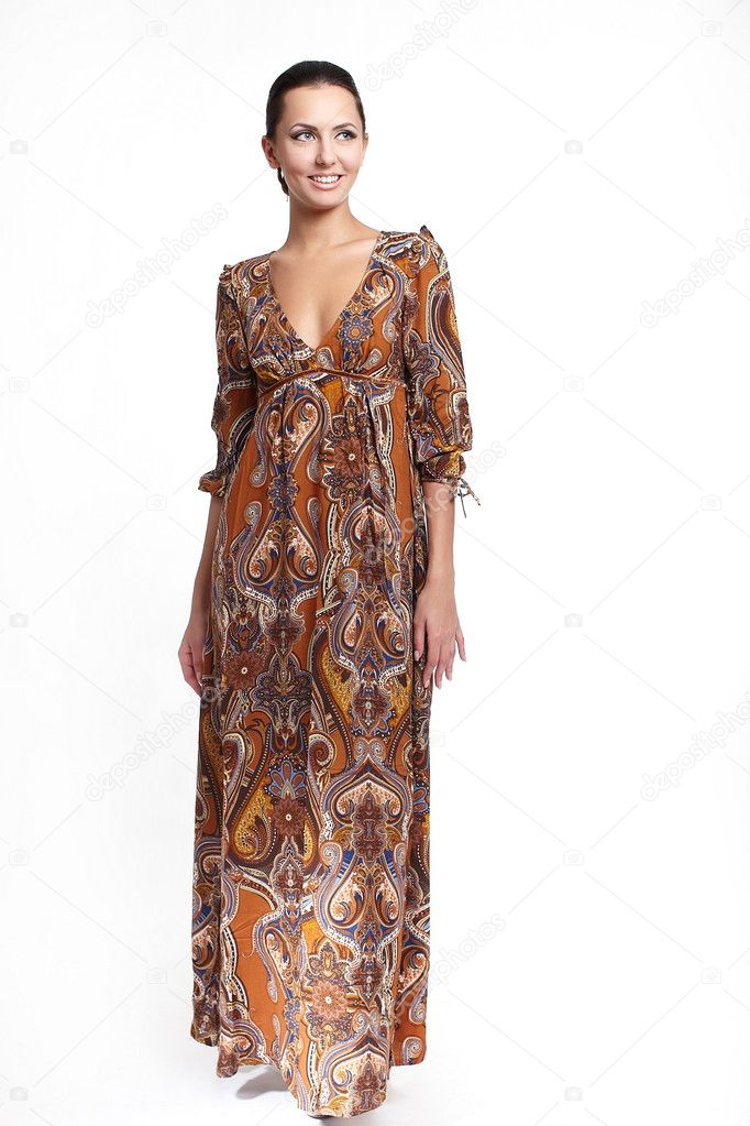 Young beautiful smiling woman in colorful brown summer dress isolated on wh