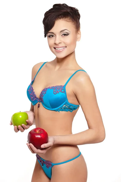 Portrait of beautiful smiling brunette woman in white lingerie with green and red apple diet isolated on white — Zdjęcie stockowe
