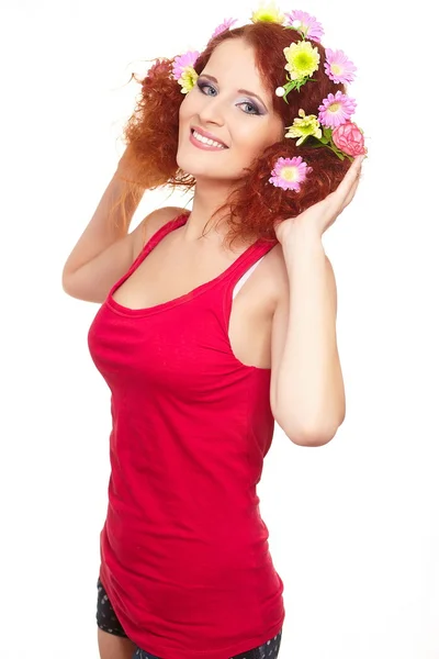 Portrait of beautiful smiling redhead ginger woman in red cloth with yellow pink colorful flowers in hair isolated on white with lemon in hands — Stock Photo, Image