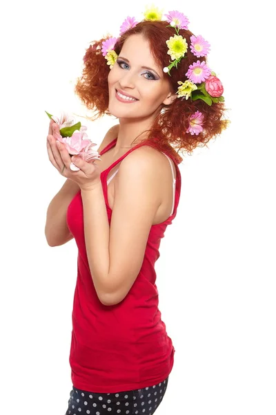 Portrait of beautiful smiling redhead ginger woman in red cloth with yellow pink colorful flowers in hair isolated on white with lemon in hands — Stock Photo, Image