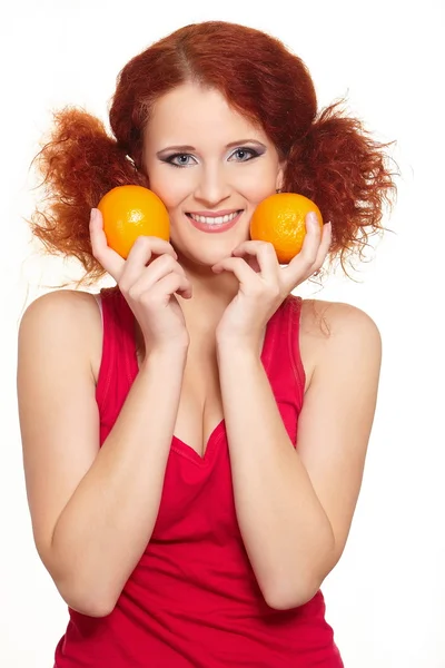 Portrait of beautiful smiling redhead ginger woman in red cloth isolated on white with oranges — Stock Photo, Image