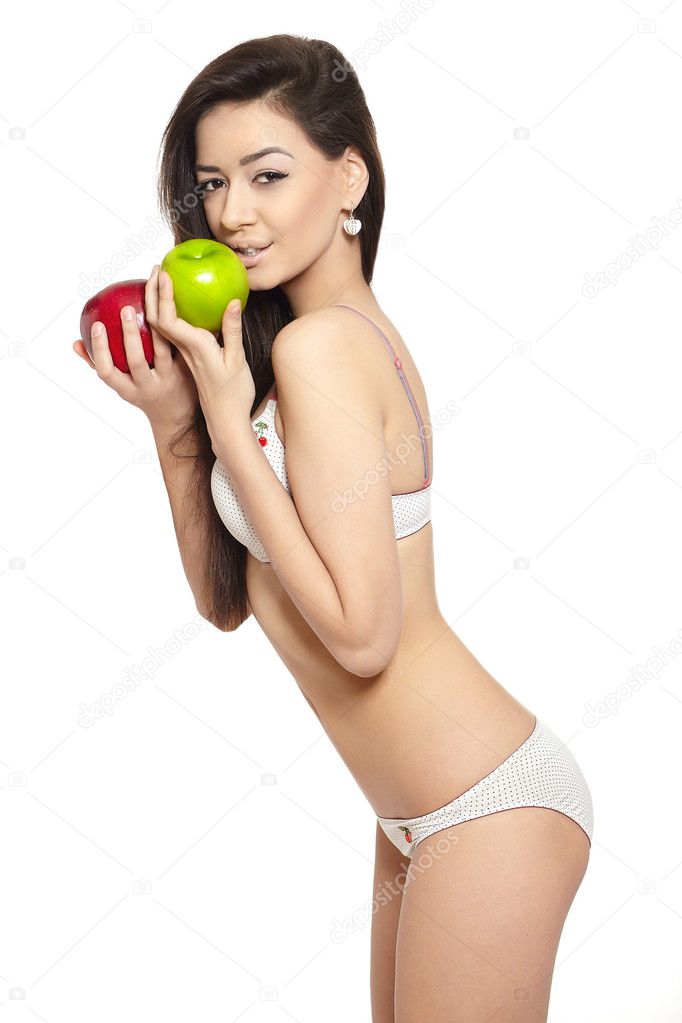 Portrait of beautiful brunette woman in white lingerie holding red apple tasting green apple diet isolated on white