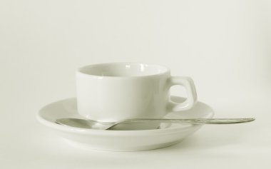 A white coffee cup and saucer