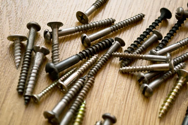 stock image Screws on the wooden floor