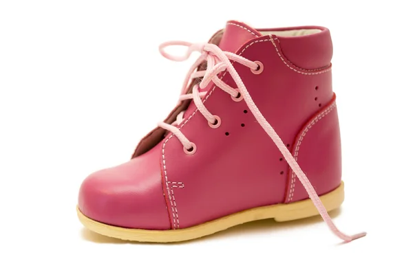 Рожеве дитяче взуття на білому тлі Стокове Фото