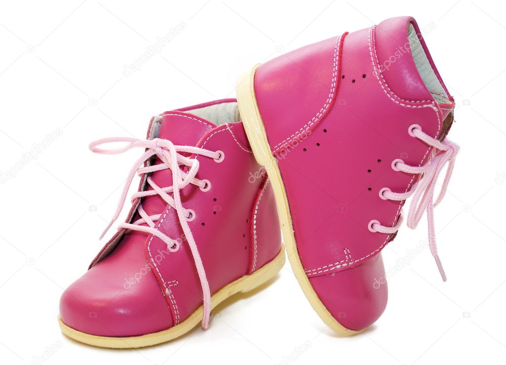 Pink baby shoes on a white background
