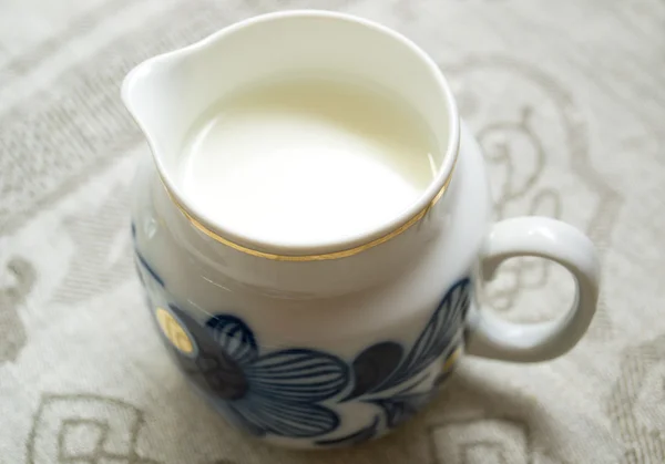 Jarro de leite na mesa — Fotografia de Stock