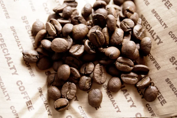 Coffee beans on linen tablecloths — Stock Photo, Image