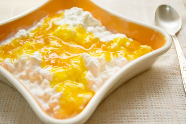 Cottage cheese with jam in the orange bowl Stock Photo