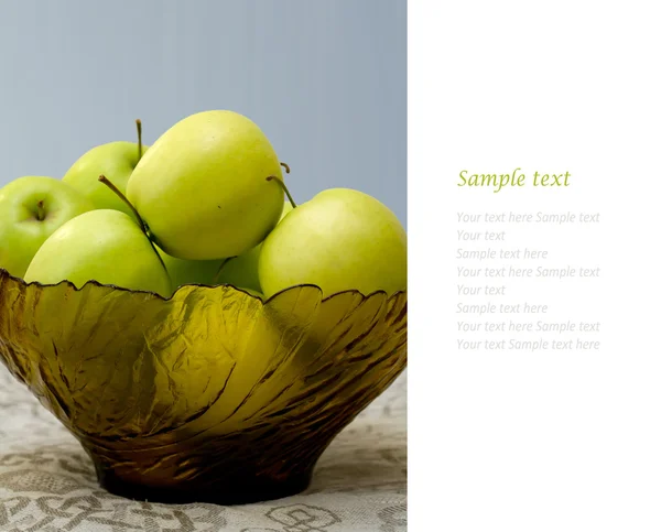 Green apples in a glass vase on the table cloth — Stock Photo, Image