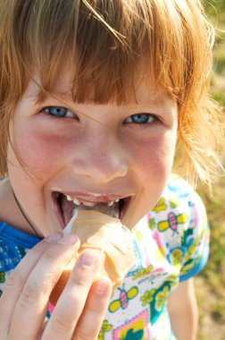 Happy girl eating ice-cream clipart