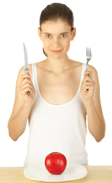 Muchacha sonriente con tenedor y cuchillo cerca del plato con manzana —  Fotos de Stock