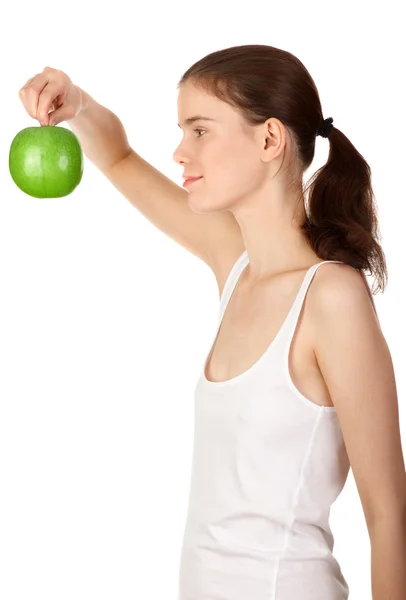 Zielone jablko w uśmiechający się dziewczynkę za rękę — Zdjęcie stockowe