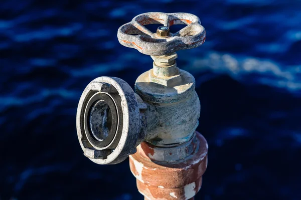 Old rusty water valve at pier — Stock Photo, Image