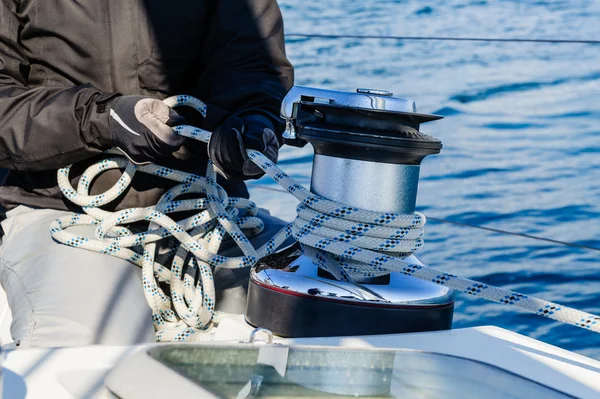 Crew work with genoa sheet rope and winch on sailing boat. — Stock Photo, Image