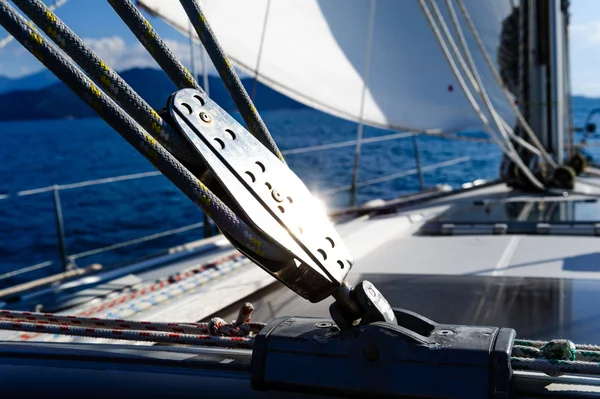 Sailing yacht rigging equipment with bright spot of light — Stock Photo, Image