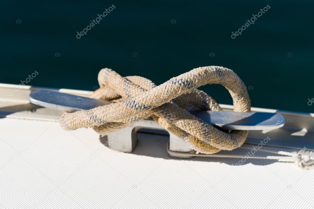 Close up picture of mooring line attached to the sailing yacht cleat