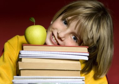 Pretty smiling boy holding books clipart