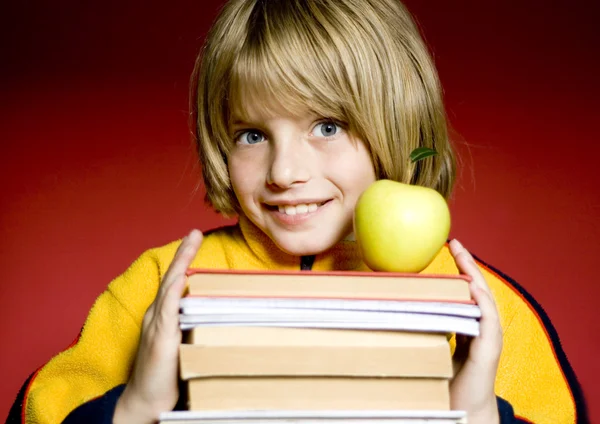 Young boy holding a book — Stock Photo, Image