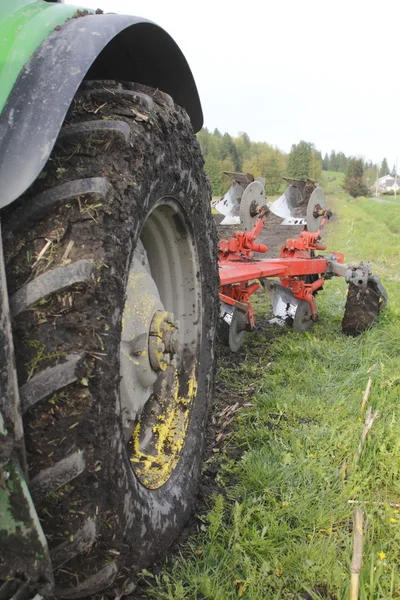 Traktor däck och plog — Stockfoto