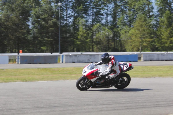 stock image Motorcyclist races down track