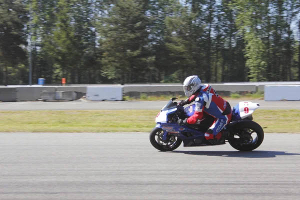 stock image Motorcyclist Speeds around track