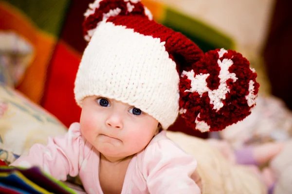 Cute little baby in wool hat with big pompoms — Stock Photo, Image