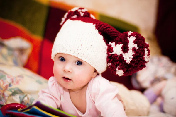 Cute little baby in wool hat with big pompoms — Stock Photo, Image