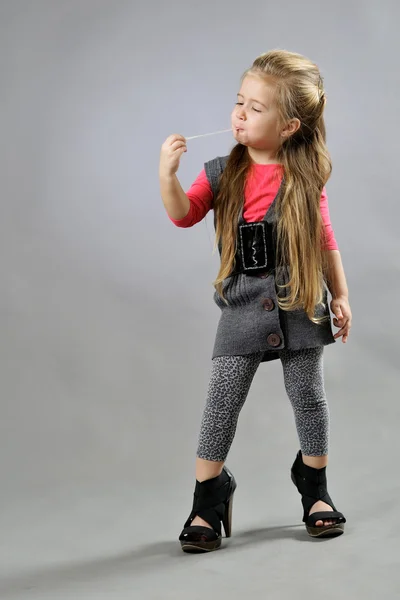 Little girl in studio on gray background — Stock Photo, Image