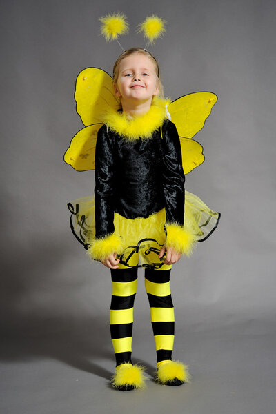 Small girl is dressed at bee costume