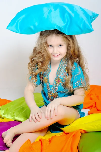 Portrait of a little girl who played with colored pillow — Stock Photo, Image