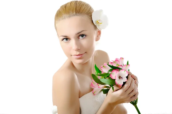 Beautiful girl with an orchid in her hair — Stock Photo, Image