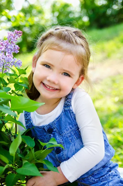 Портрет улыбающейся милой маленькой девочки на улице — стоковое фото