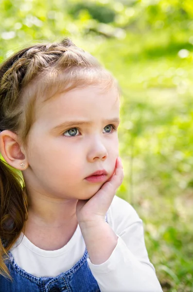 Portrait of thinking little girl outdoor — Stok Foto