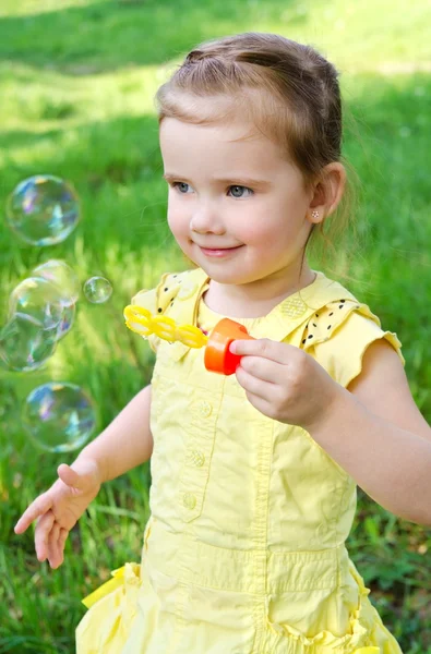 stock image Portrait of little girl blowing soap bubbles