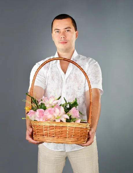 Portrait of young man with flowers — Stock Photo, Image