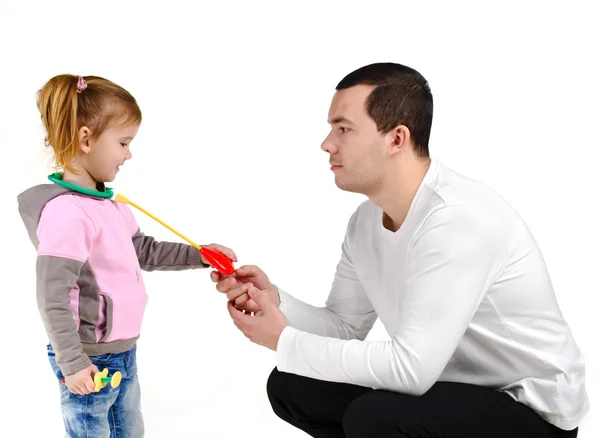 Father and daughter playing with a stethoscope syringe — Stock Photo, Image
