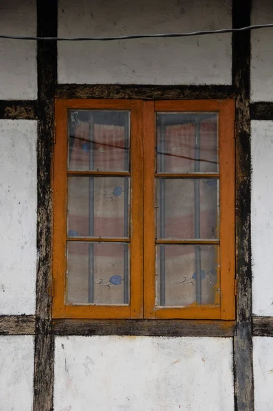 stock image Orange latticed window with brown framework