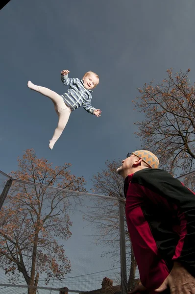 stock image Happy baby jumping up from the springboard