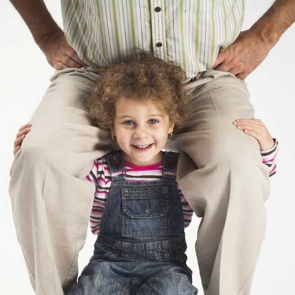 Happy toddler girl holding father on shoulders — Stock Photo, Image