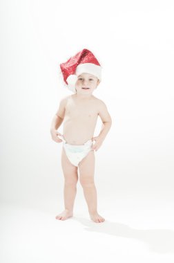 Cute smiling baby toddler girl wearing santa's hat and diapers clipart