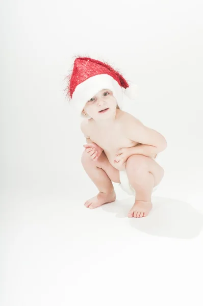 Adorable baby toddler girl wearing santa's hat and diapers — Stock Photo, Image