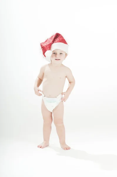 Leuke glimlachende baby peuter meisje dragen santa's hoed en luiers — Stockfoto