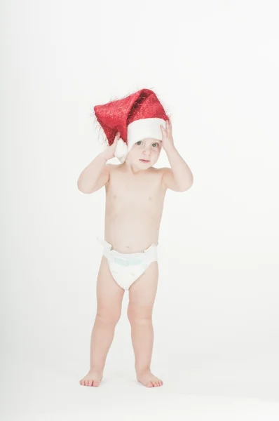 Lindo bebé niña pequeña con sombrero de santa y pañales —  Fotos de Stock