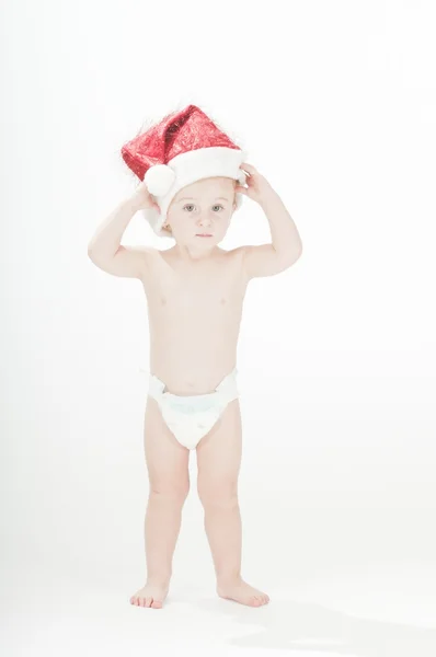 Lindo bebé niña pequeña con sombrero de santas y pañales —  Fotos de Stock