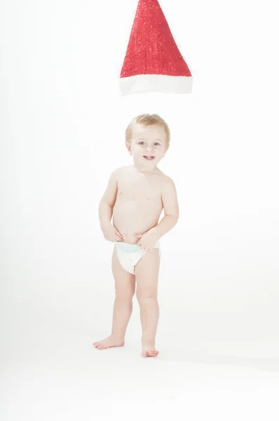 Weihnachtsmann-Hut hängt über entzückendem Baby-Mädchen — Stockfoto