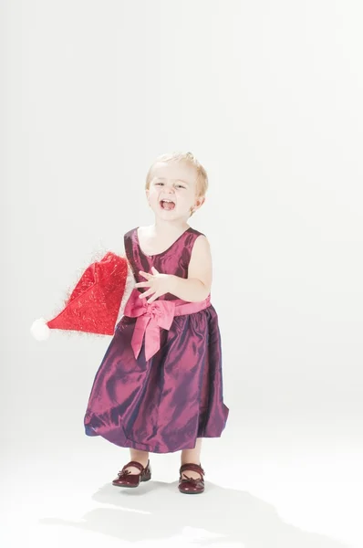 Happy dressed-up baby toddler girl with santas hat — Stock Photo, Image